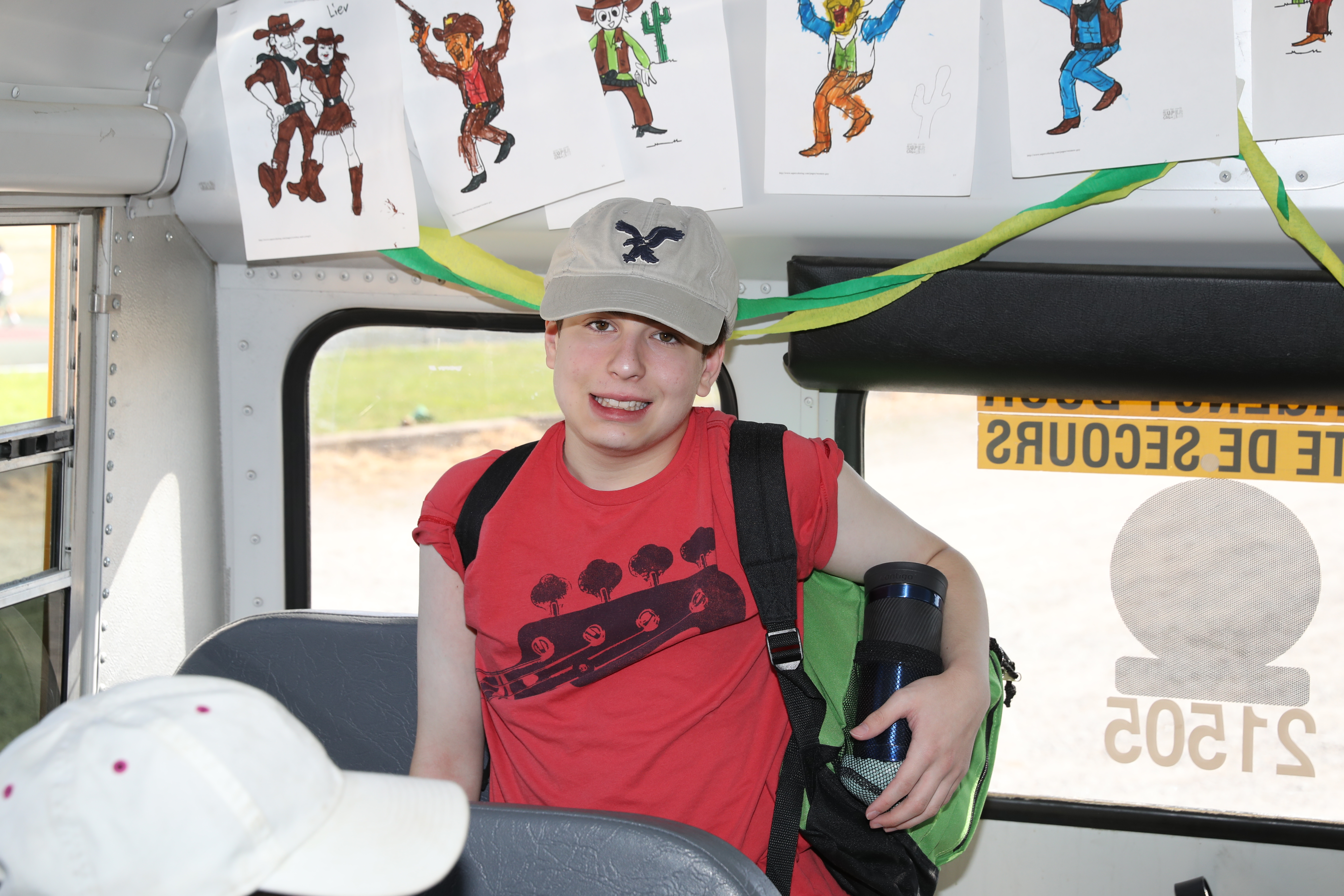 A Senior camper showing off the bus decorations after arriving at camp